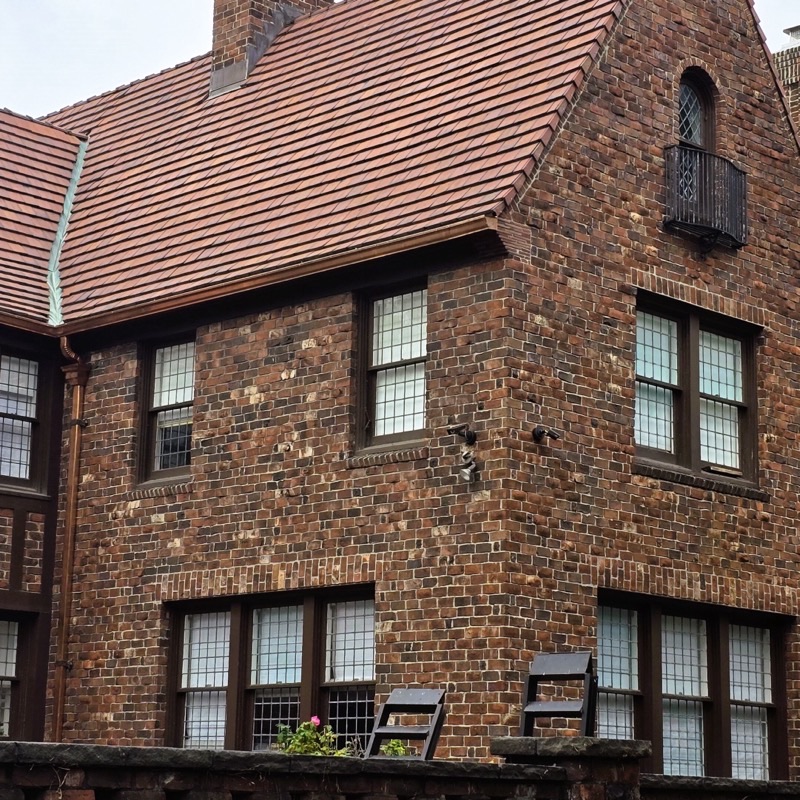 Brick Tudor-style house with a steep tiled roof and leaded windows in Forest Hills Gardens, Queens