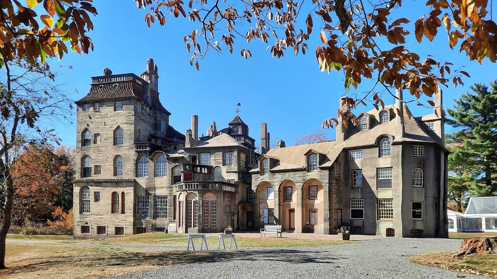 Fonthill Castle, Henry Mercer's towered concrete home in Doylestown, PA, under a clear blue autumn sky
