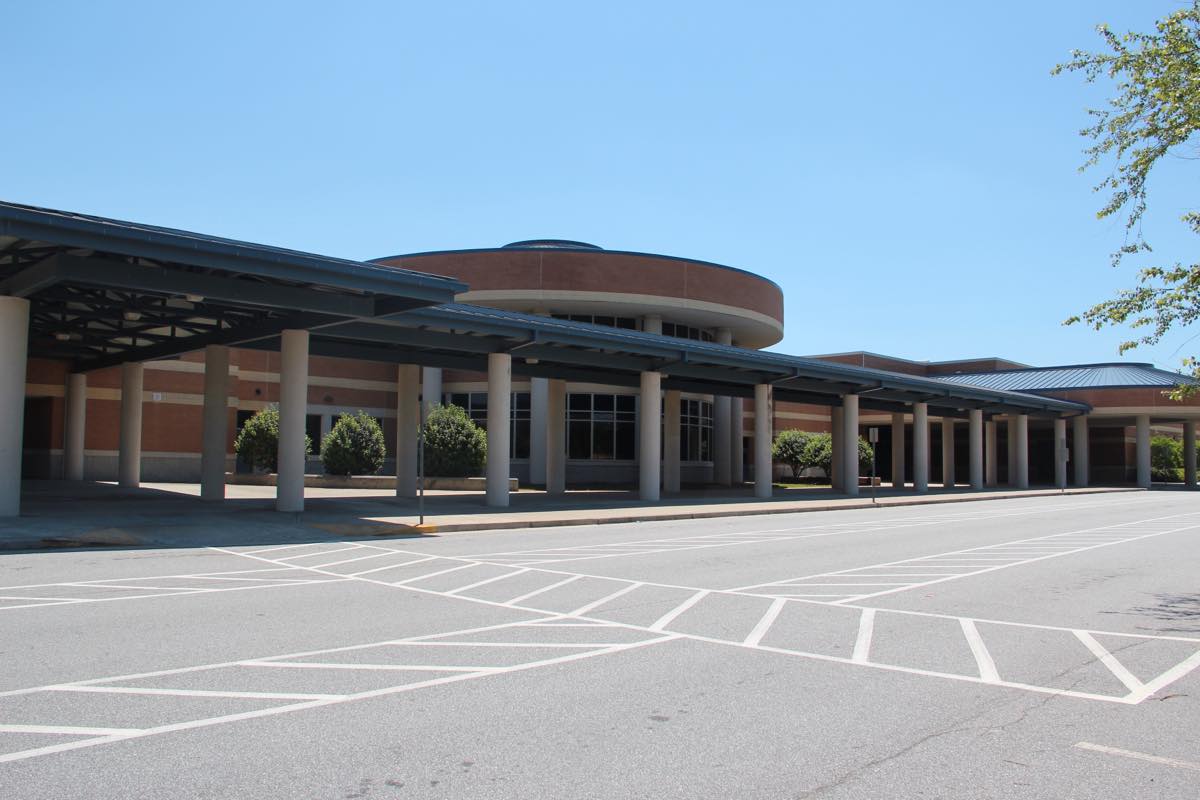 Covered entrance walkway and brick front of Norcross High School