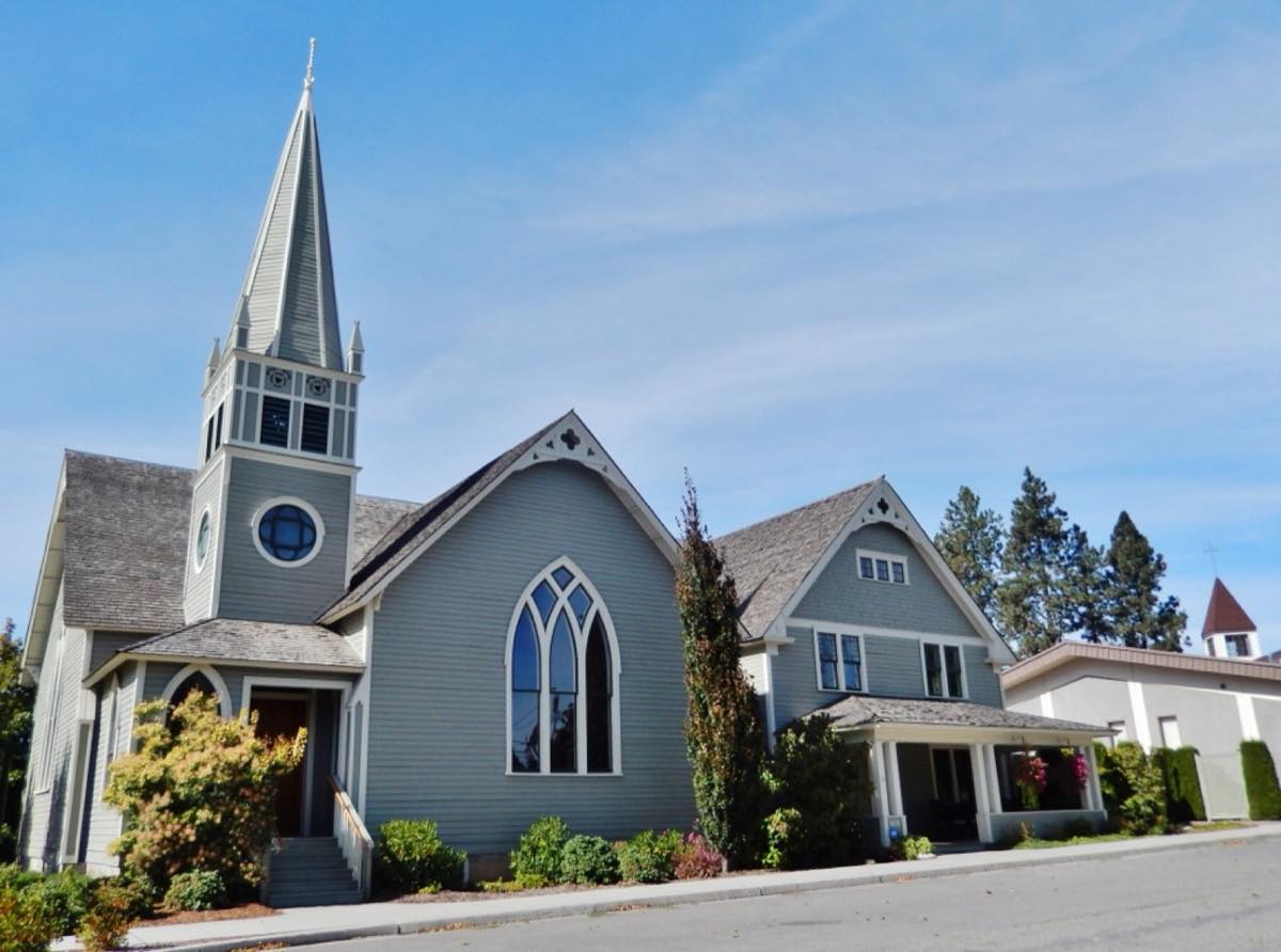 Post Falls Community Presbyterian Church, a gray wood-sided church with a tall steeple