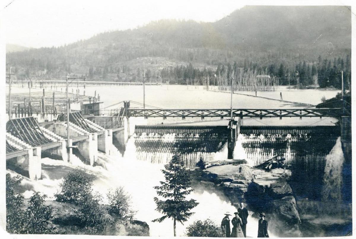 Historic sepia photo of the Post Falls Dam north channel with water pouring over the falls