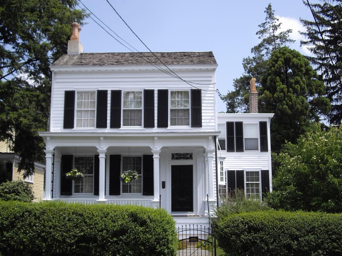 Albert Einstein's white clapboard house at 112 Mercer Street behind hedges