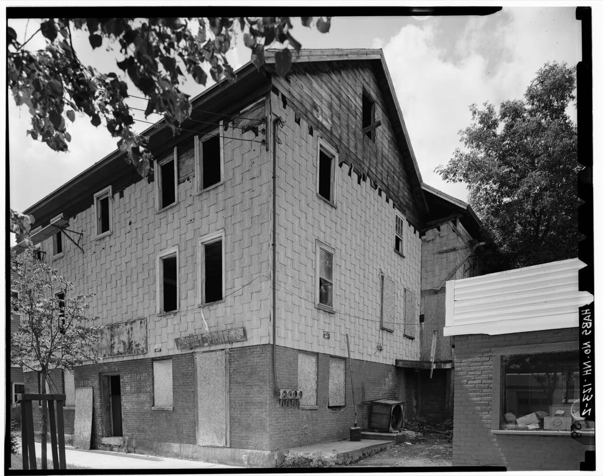 Black-and-white survey photo of the old 17-19 Market Street houses in Somersworth, a three-story block with a brick ground floor
